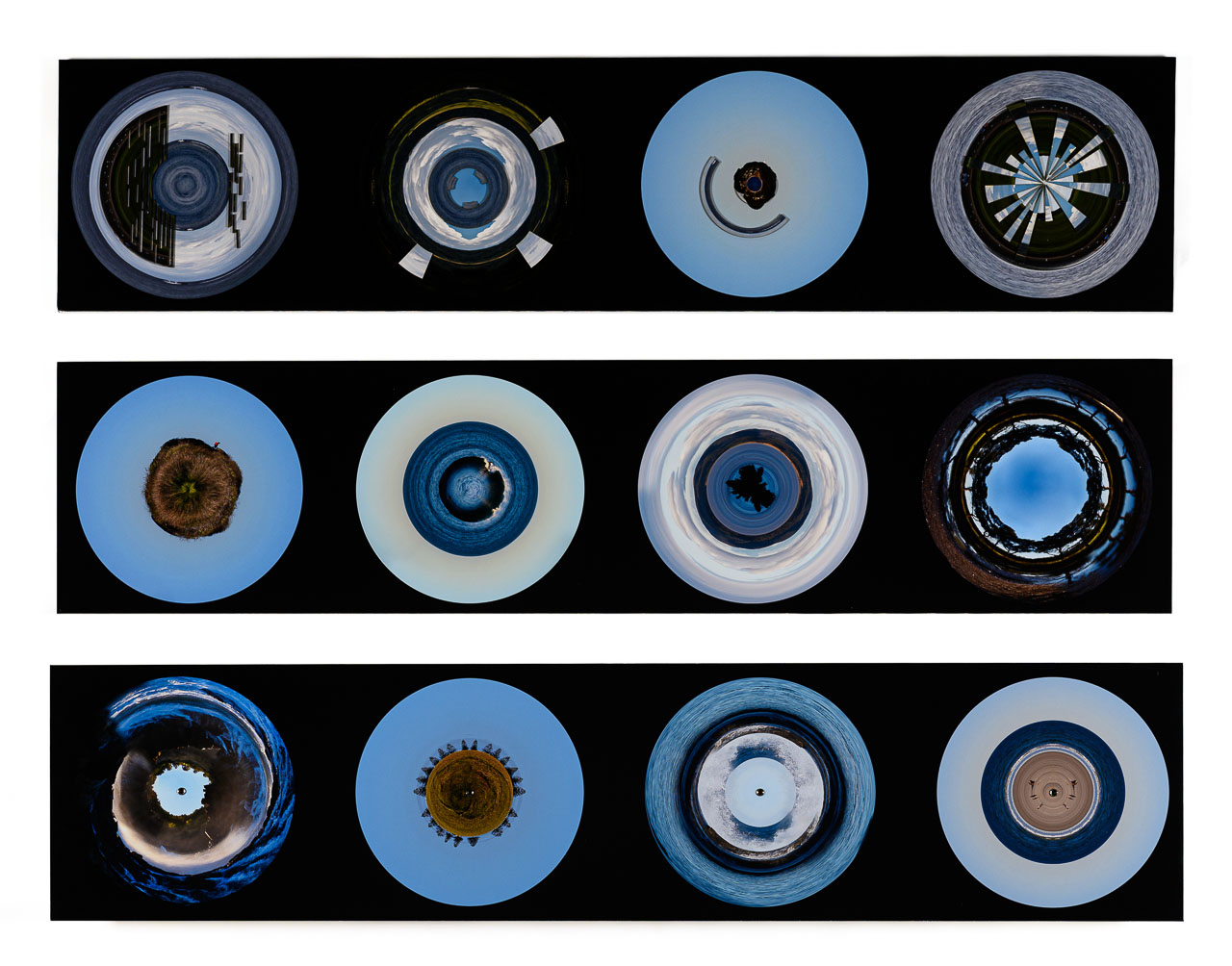 Three long black panels featuring blue circles, each made up of different tones and concentric shapes. The circular images are stills taken from the work which was expereineced through a VR headset.