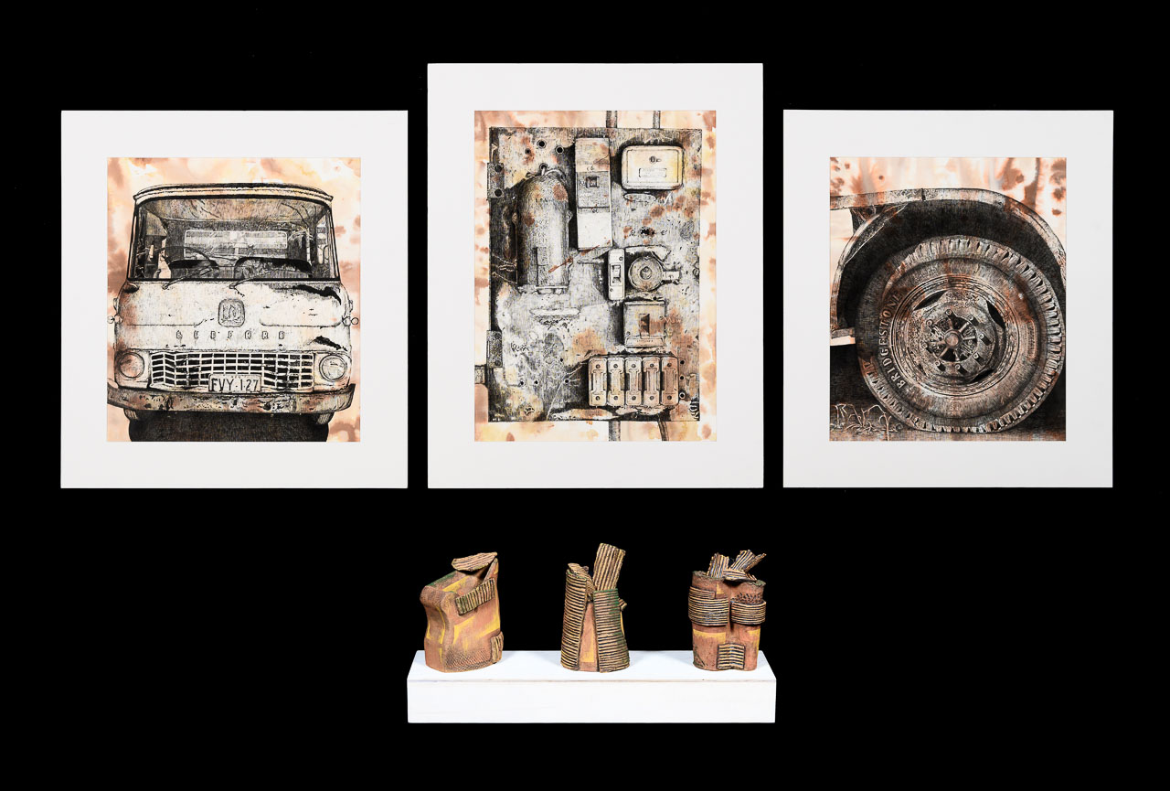 Three drawings of rusted equipment and three clay sculptures in rust colours of abstract shapes.