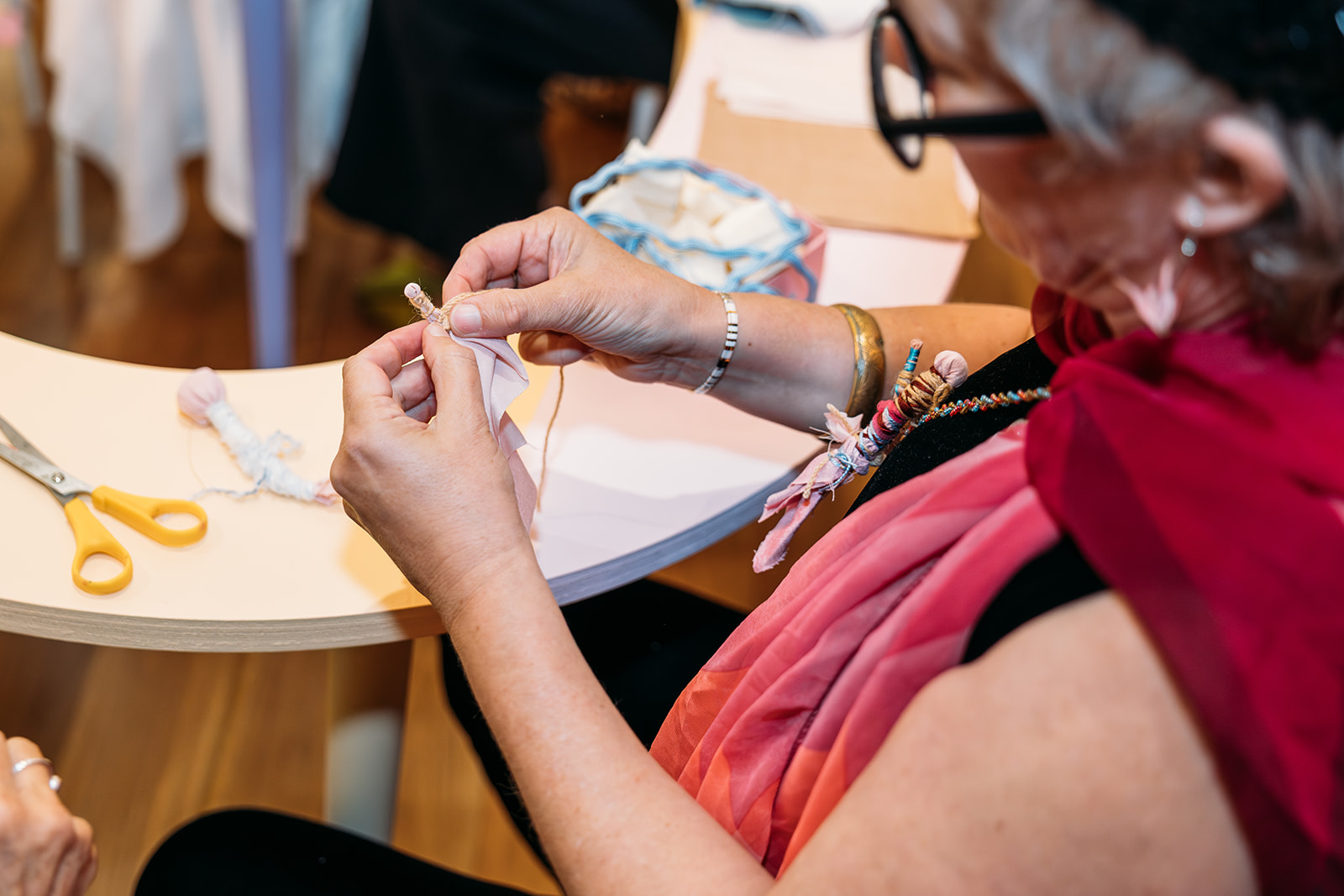 Photograph of woman participating in collaborative artmaking project.