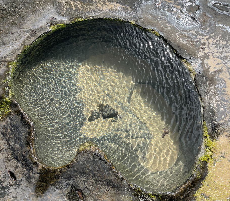 Aerial photograph of a rock pool with rippling water.