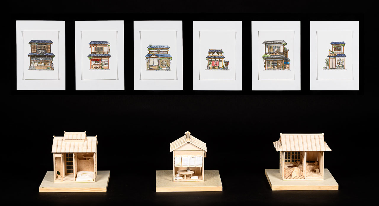 Three small models of Japanese buildings accompanied by a series of six drawings depicting Japanese shop fronts.