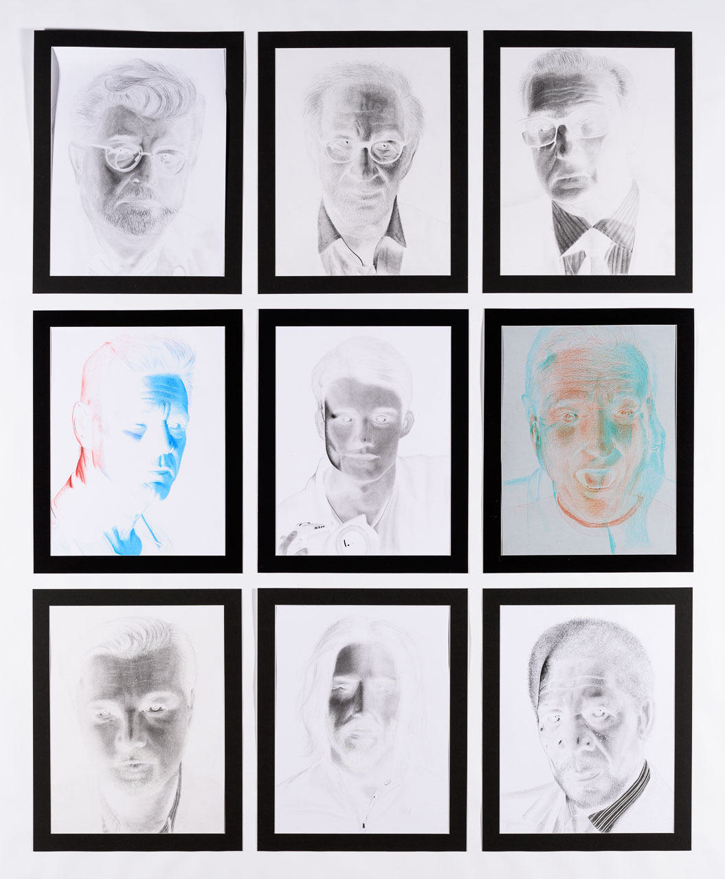 A series of nine drawings of famous male faces with the colours inverted.