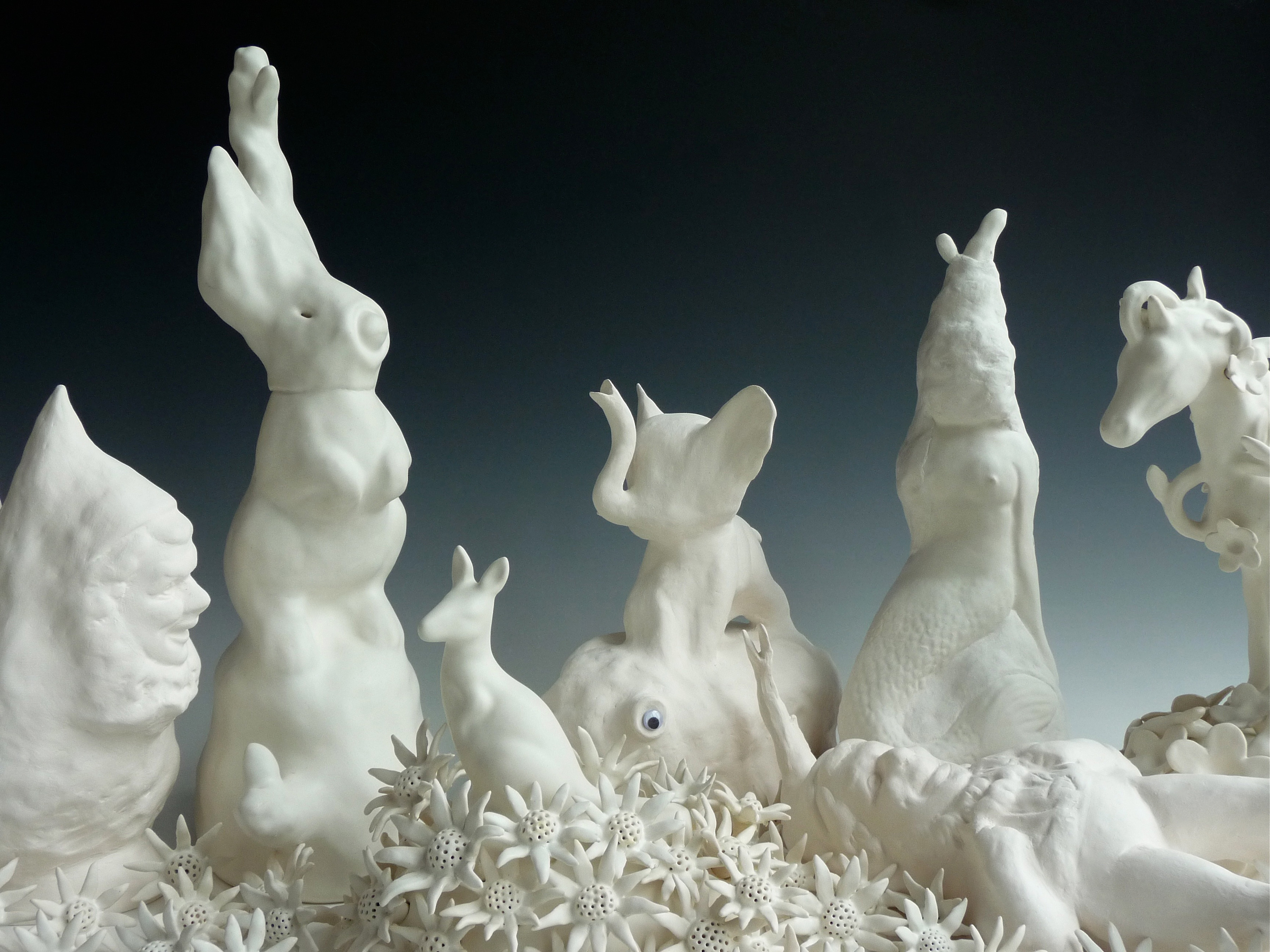 Detail of ceramic work by artist Lynda Draper of animals and flowers.
