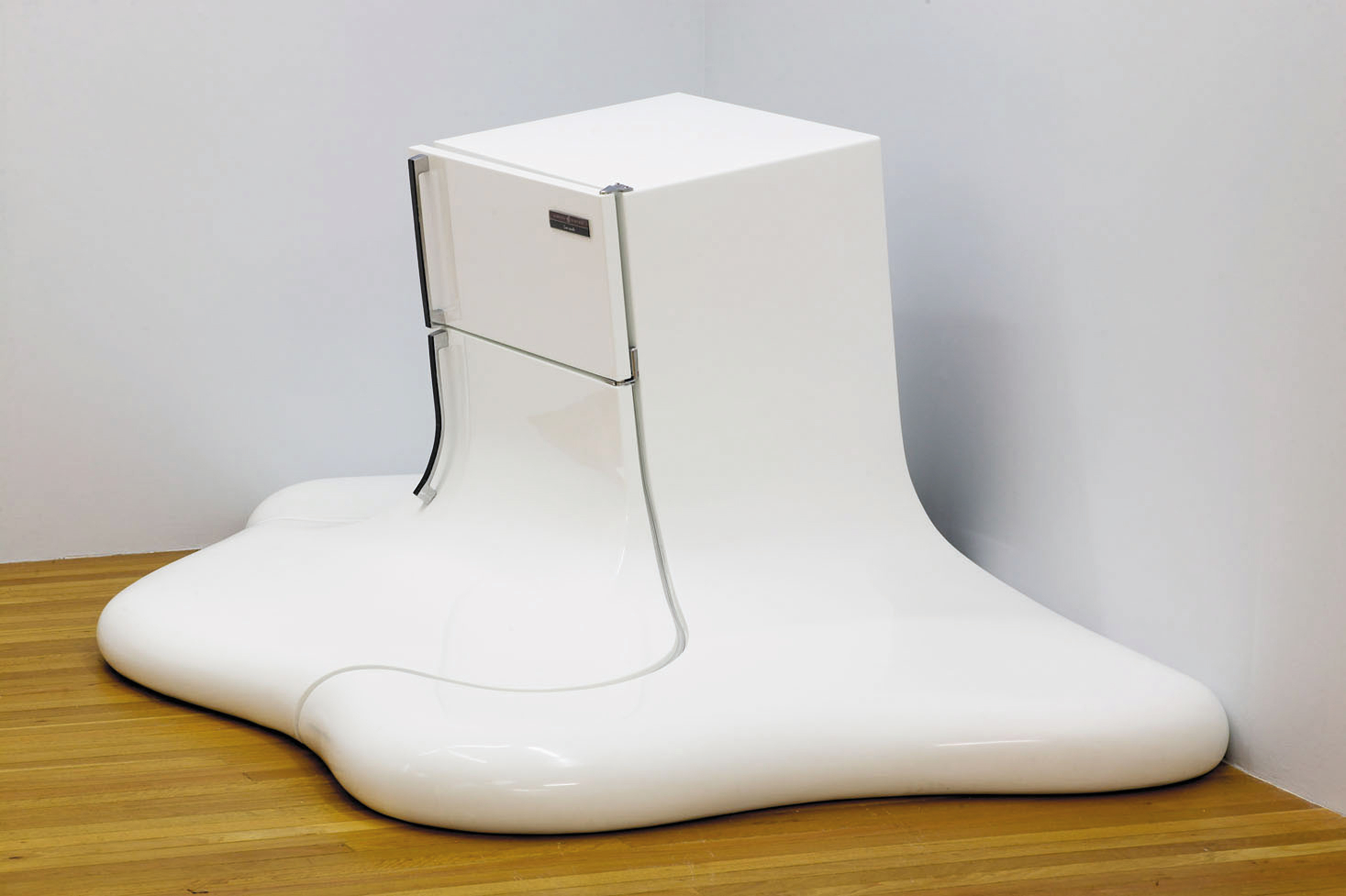 A sulpture of a fridge that looks liek it is melting into the floor by artist Christian de Vietri.