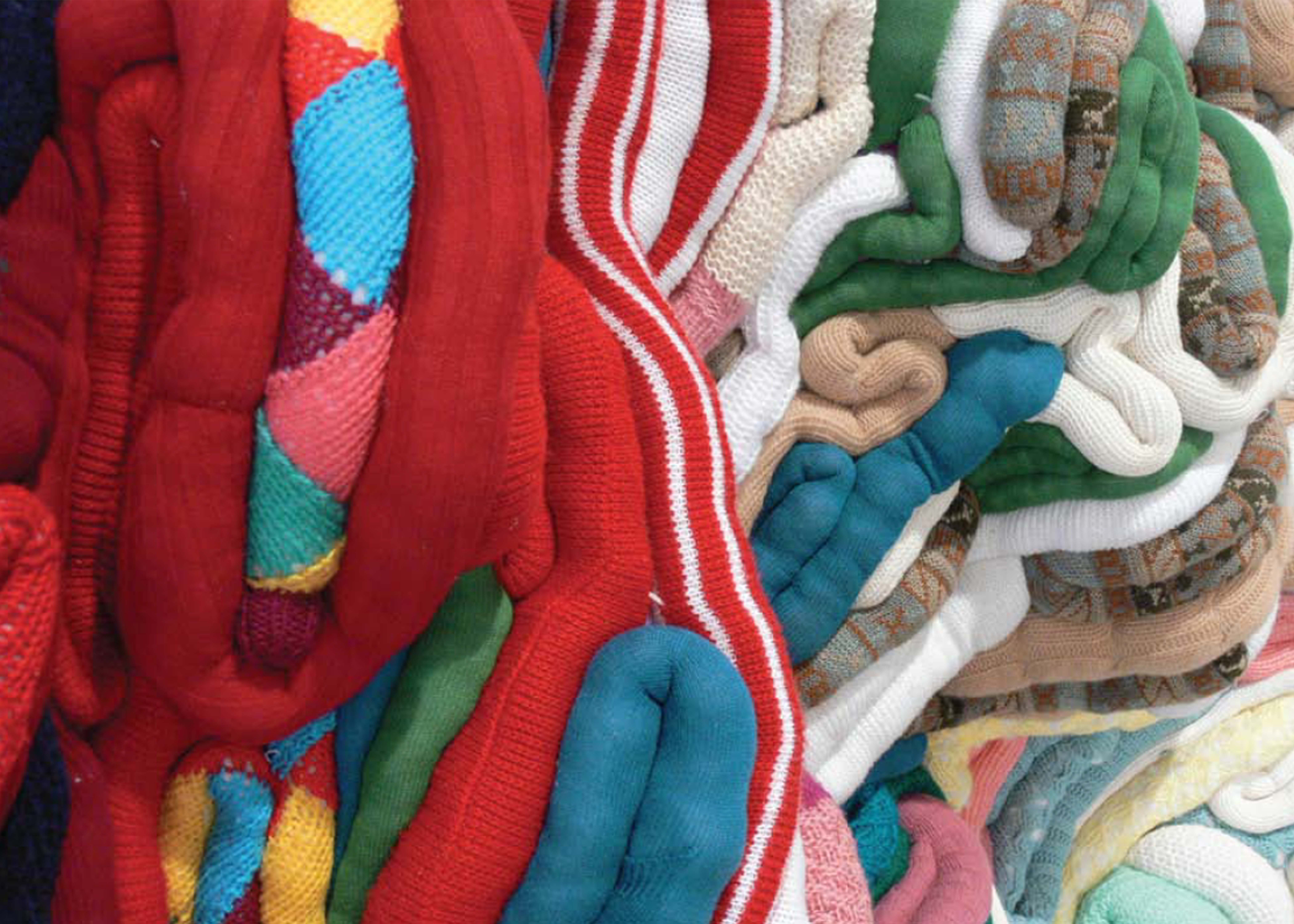 Close up photograph of a colourful knitted structure.