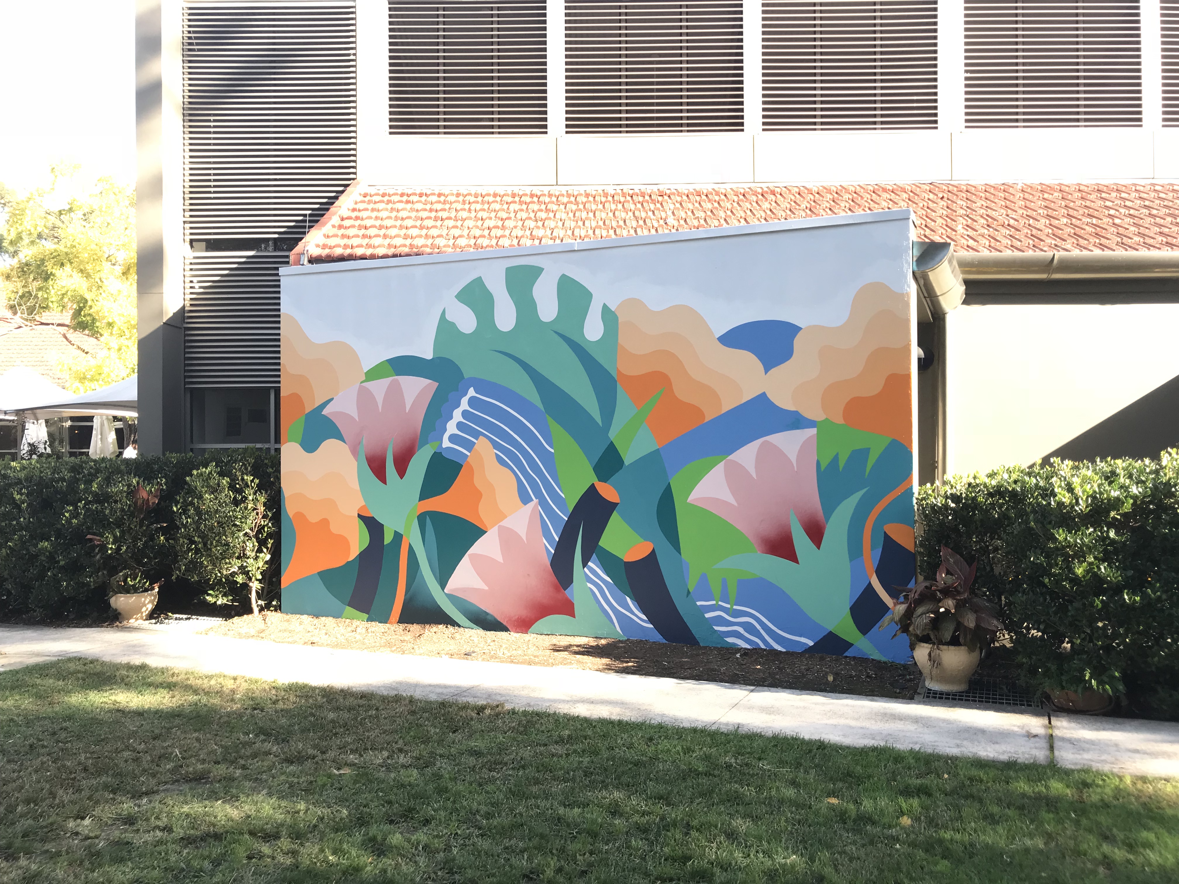 A brightly coloured large outdoor mural.