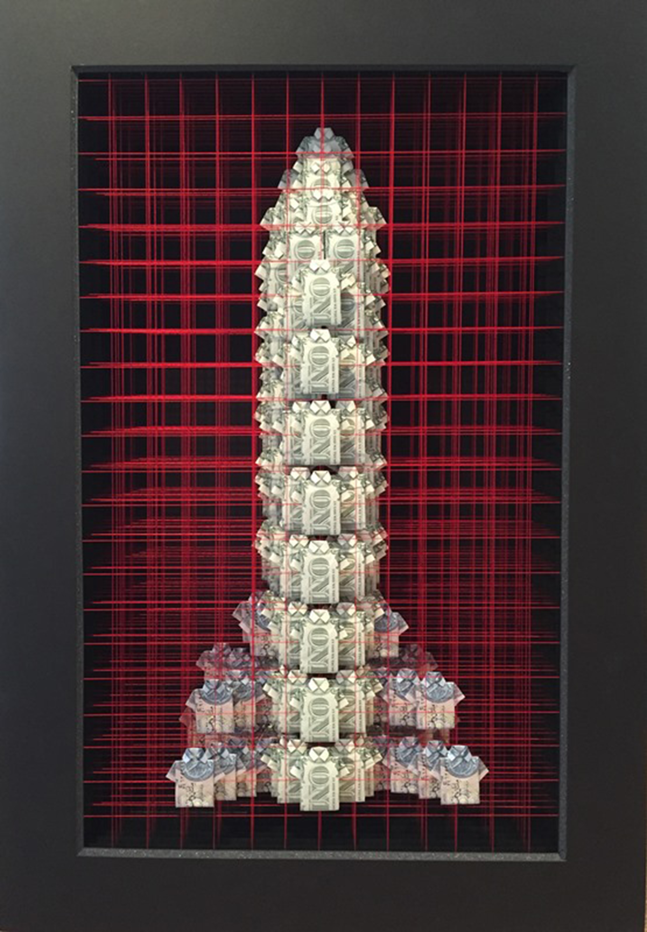 A tower like shape made from US dollar bills and Iraqui dinari folded into the shape of short sleeved shirts. The shirts are stacked in a grid made from red cotton threads.