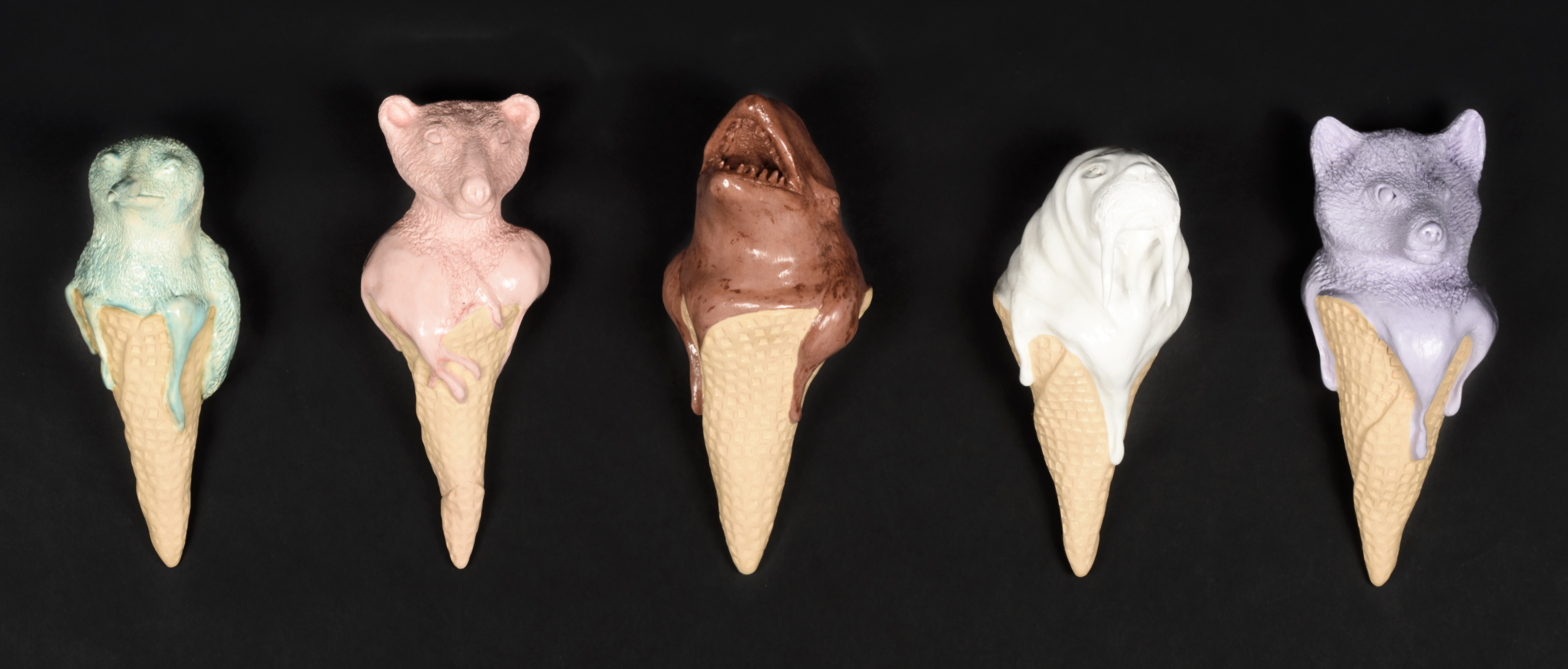 Five ceramic sculptures that look like melting icecream cones but each scoop of icecream is a bust of a different animal.