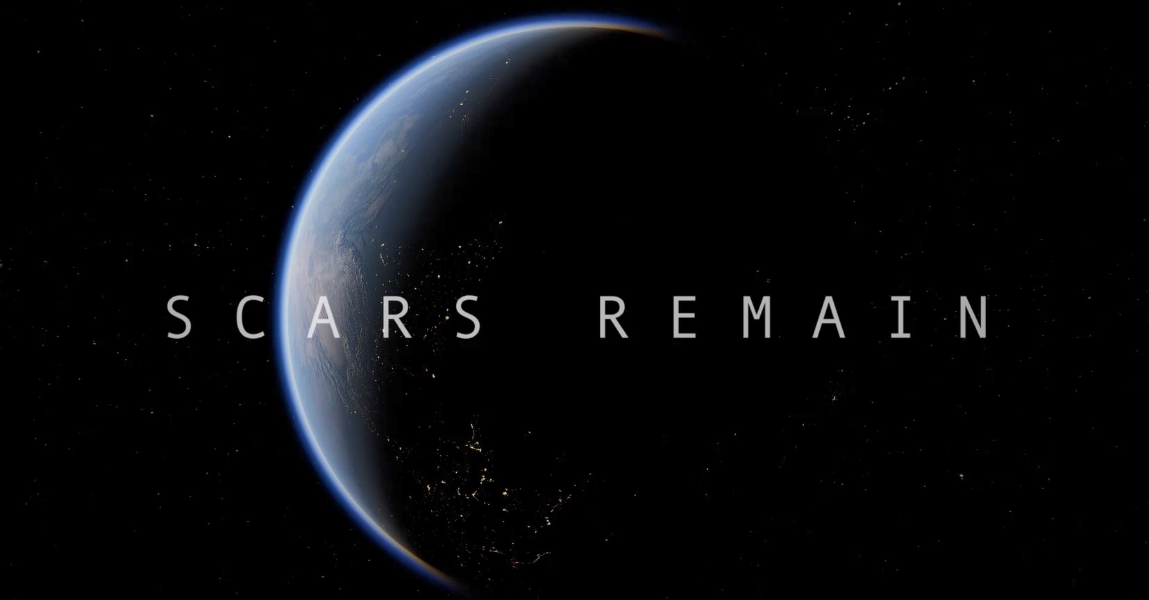 Still of title screen from student film featuring planet earth in heavy shadow with the title text "Scars Remain" overlayed.
