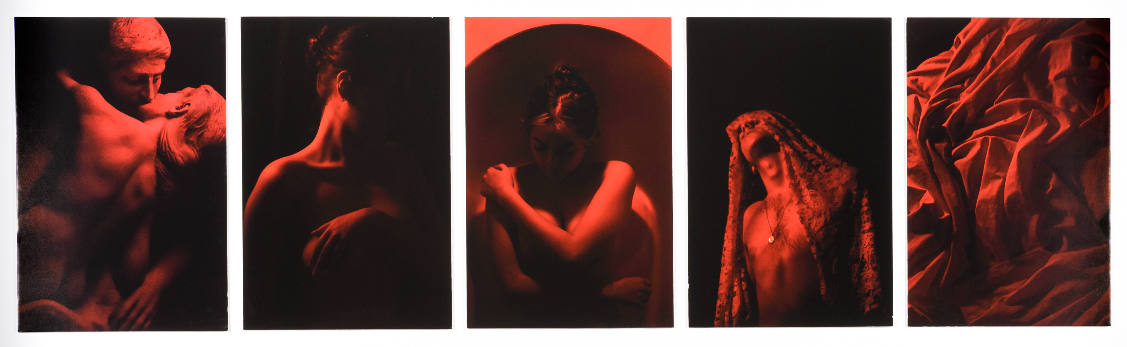A series of five dramatic red toned photographs of a sculpture, male and female figures and crumpled fabric.